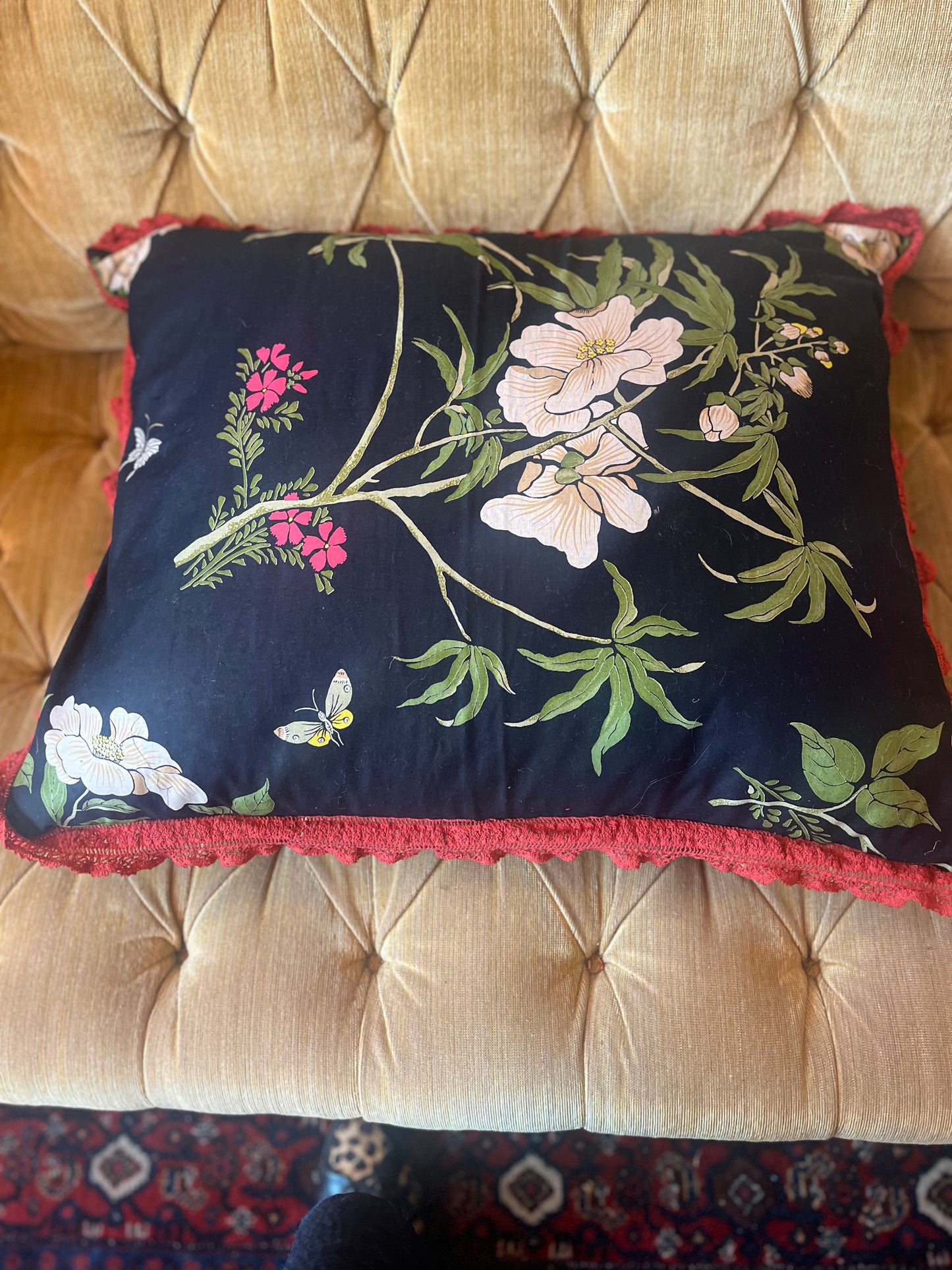 Black botanical print cushion with contrasting fringe