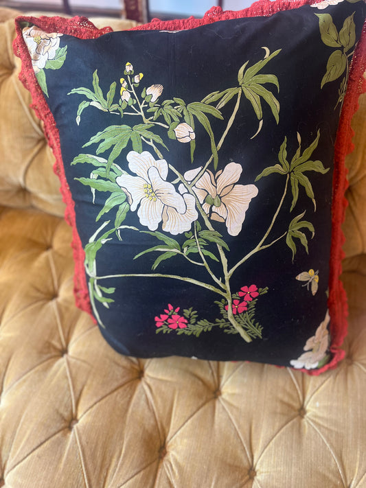 Black botanical print cushion with contrasting fringe