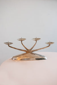 A pair of four pronged silver plated candelabras